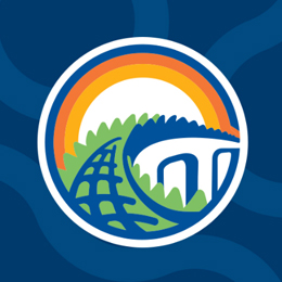 Circular logo with a landscape: green fields, blue river, and colorful rainbow arc over a white half-circle. A globe is on the left.